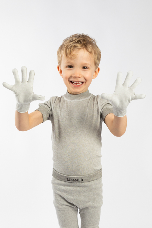 Kinder-Fingerhandschuhe – von fröhlichem Kind getragen, zeigt alle zehn Finger; hautfreundliche Silbertextilien, elastisch und juckreizlindernd.