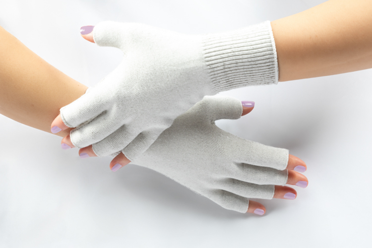 Women's gloves Worn on women's hands gently stroking each other. On a white background.